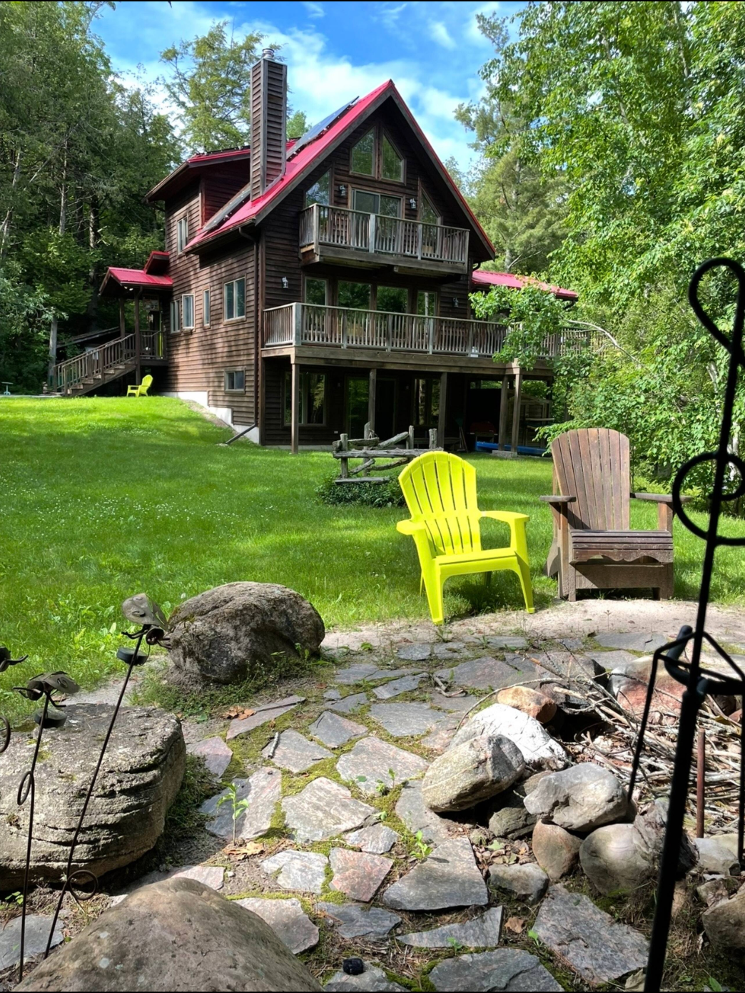 Wooden chalet with red roof and lawn